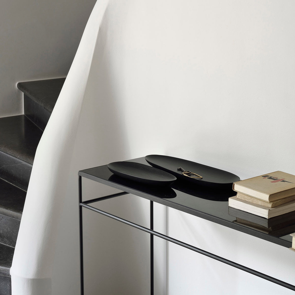 Thin Oval Boards (set of 2) by Ethnicraft, showing front view of oval boards with books in the live shot.