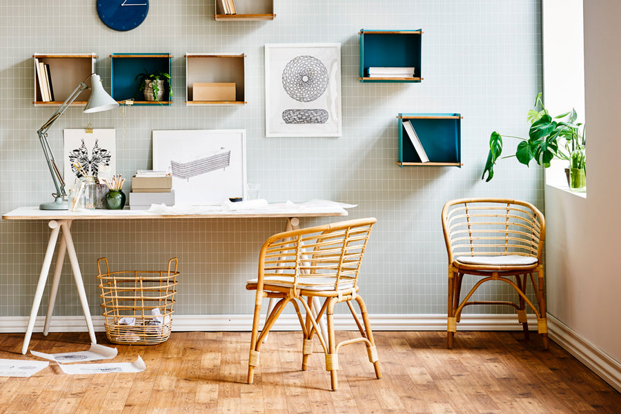 Blend Indoor Armchair by Cane-Line, showing blend indoor armchairs with table in live shot.
