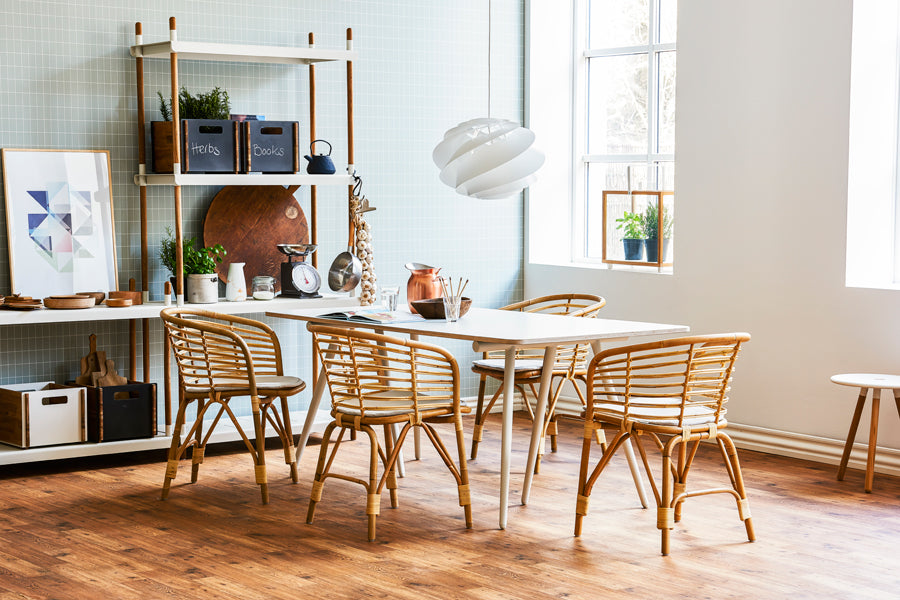 Blend Indoor Armchair by Cane-Line, showing blend indoor armchairs with table in live shot.
