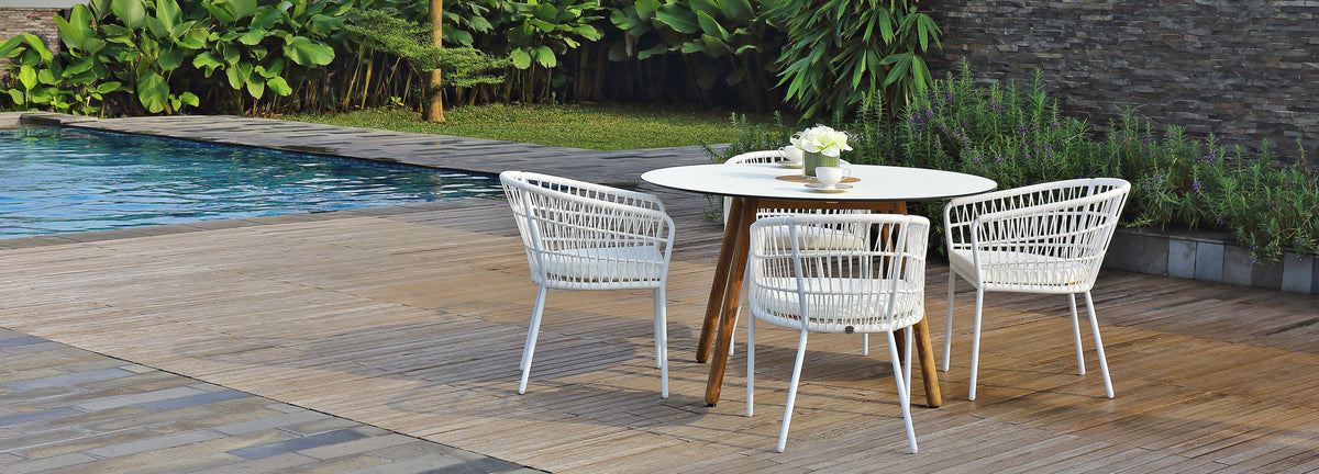 Bono Teak Dining Table by Mamagreen, showing bono teak dining table with dining chairs in live shot.