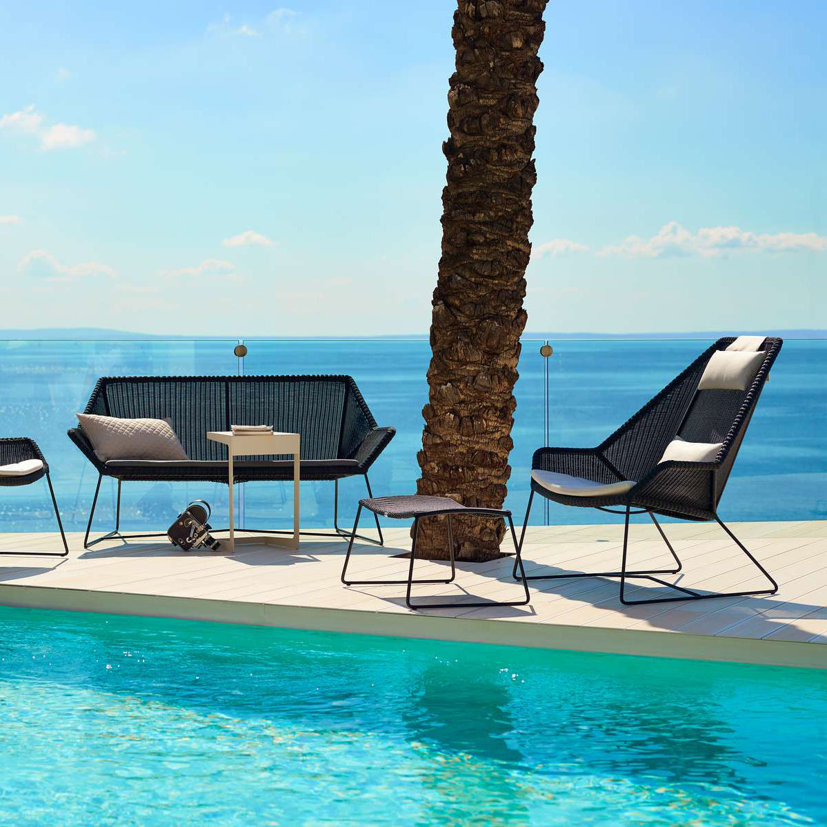 Breeze Footstool by Cane-Line, showing breeze footstool in live shot.