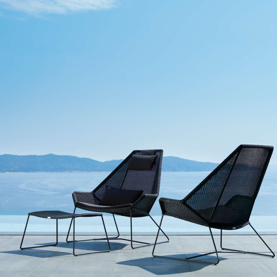 Breeze Footstool by Cane-Line, showing breeze footstool in live shot.