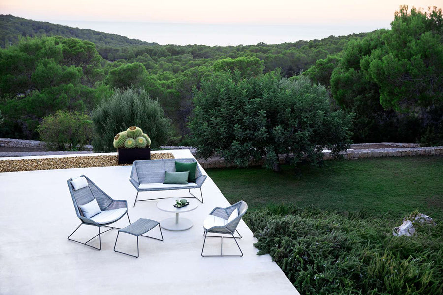 Breeze Footstool by Cane-Line, showing breeze footstool in live shot.