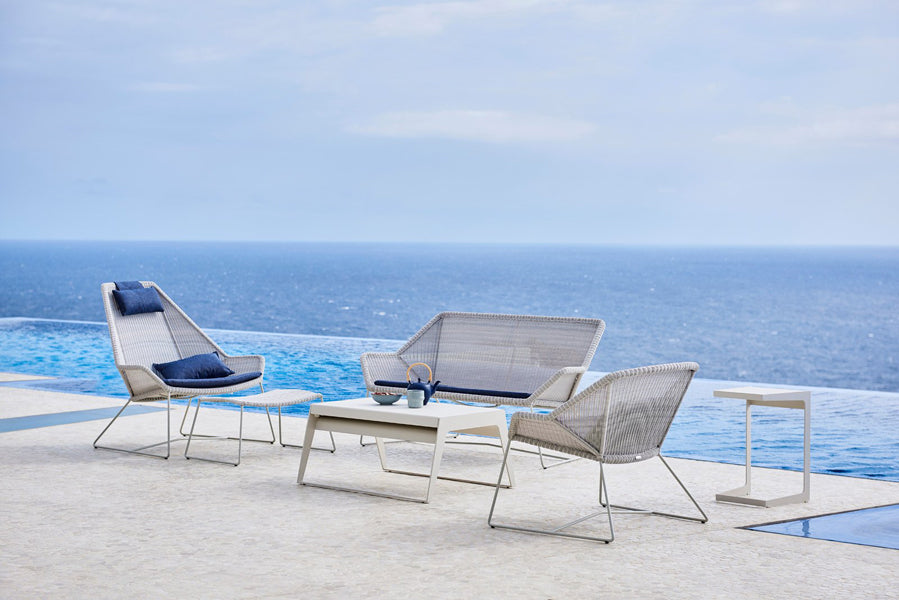 Breeze Footstool by Cane-Line, showing breeze footstool in live shot.