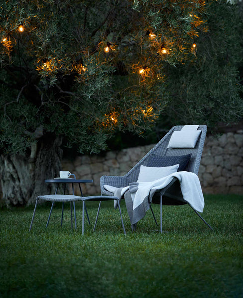 Breeze Footstool by Cane-Line, showing breeze footstool in live shot.