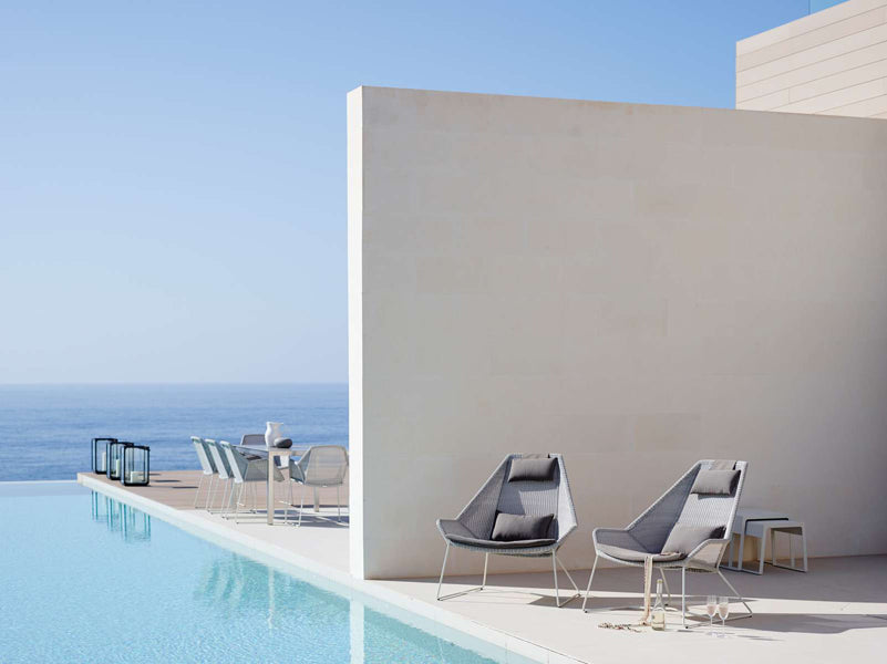 Breeze Highback Chair by Cane-Line, showing breeze highback chairs in live shot.