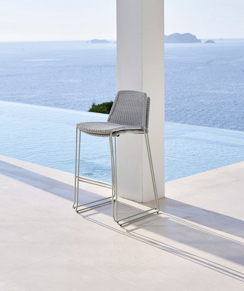 Breeze Stackable Bar Chair by Cane-Line, showing breeze stackable bar chairs in live shot.