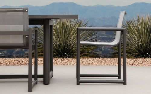 Breeze XL Outdoor Dining Chair by Harbour Outdoor, showing breeze xl outdoor dining chairs with table in live shot.
