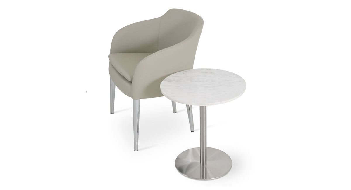 Buca Metal Dining Armchair by SohoConcept, showing light grey leatherette buca metal dining armchair & a table in the live shot.