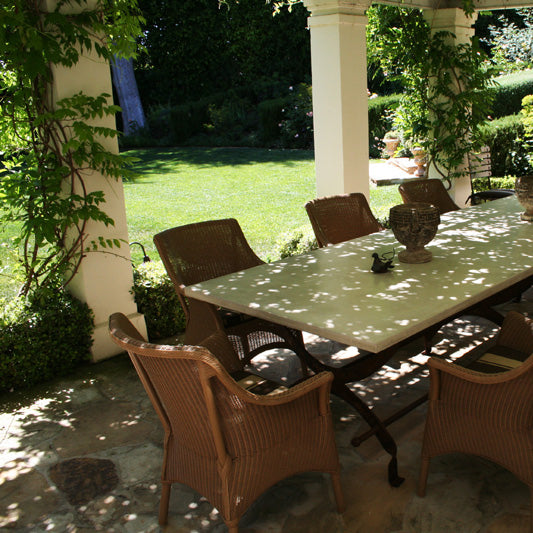 James De Wulf Campaign Dining Table by De Wulf, showing closeup view of campaign dining table with chairs in live shot.