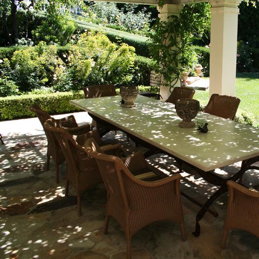 James De Wulf Campaign Dining Table by De Wulf, showing closeup view of campaign dining table with chairs in live shot.