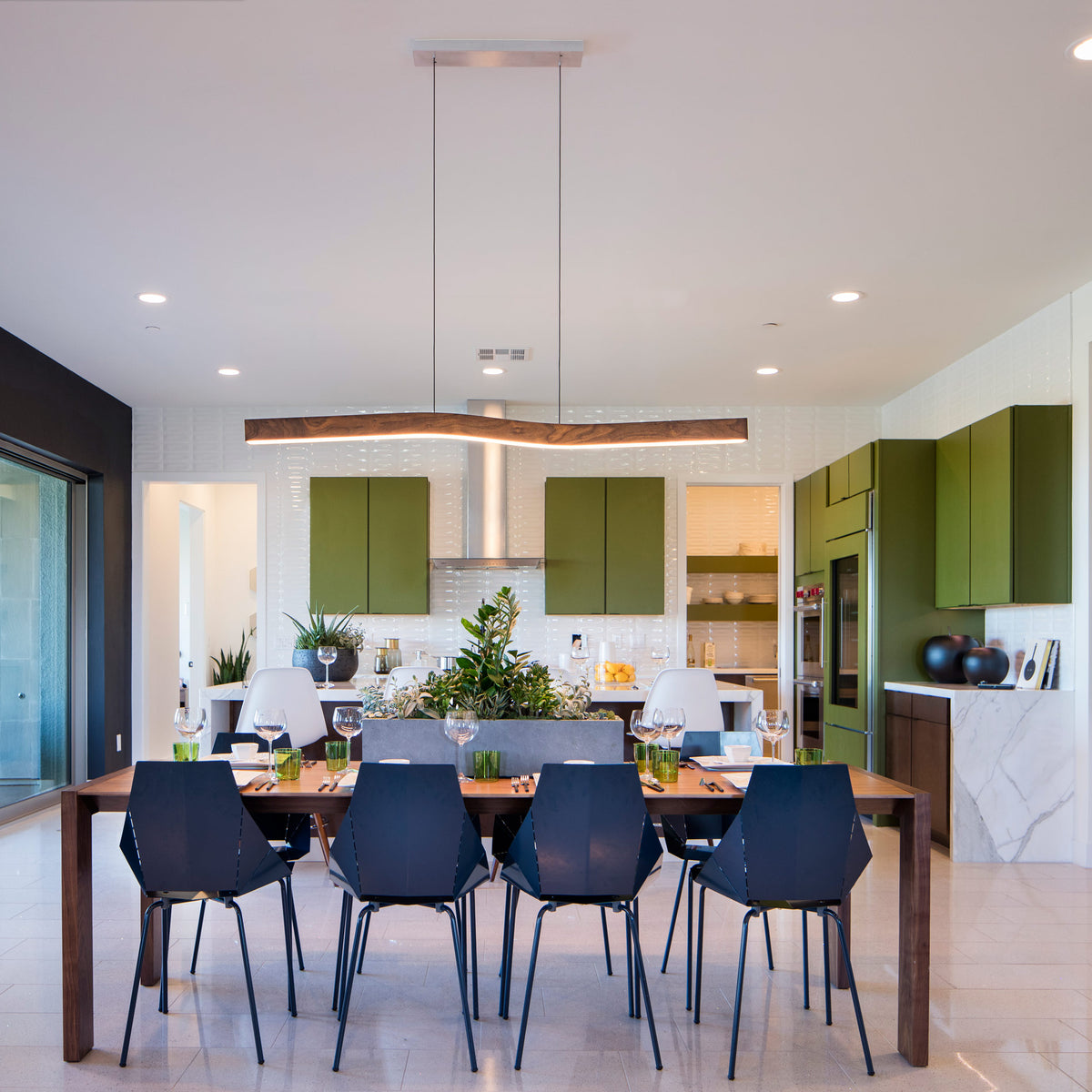 Camur LED Linear Pendant by Cerno, showing camur led linear pendant with table & chair in live shot.