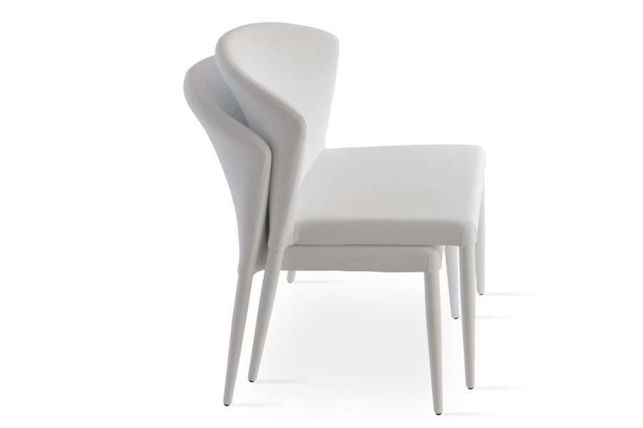Capri Full Upholstered Stackable Chair by SohoConcept, showing angle view of two chairs in white ppm.