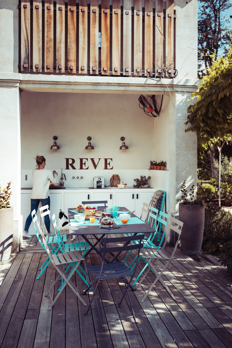 Caractere Tables by Fermob, showing angle view of table with chairs in the live shot.