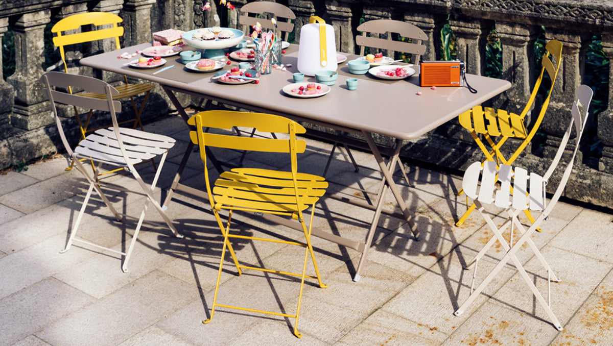 Caractere Tables by Fermob, showing angle view of table with chairs in the live shot.
