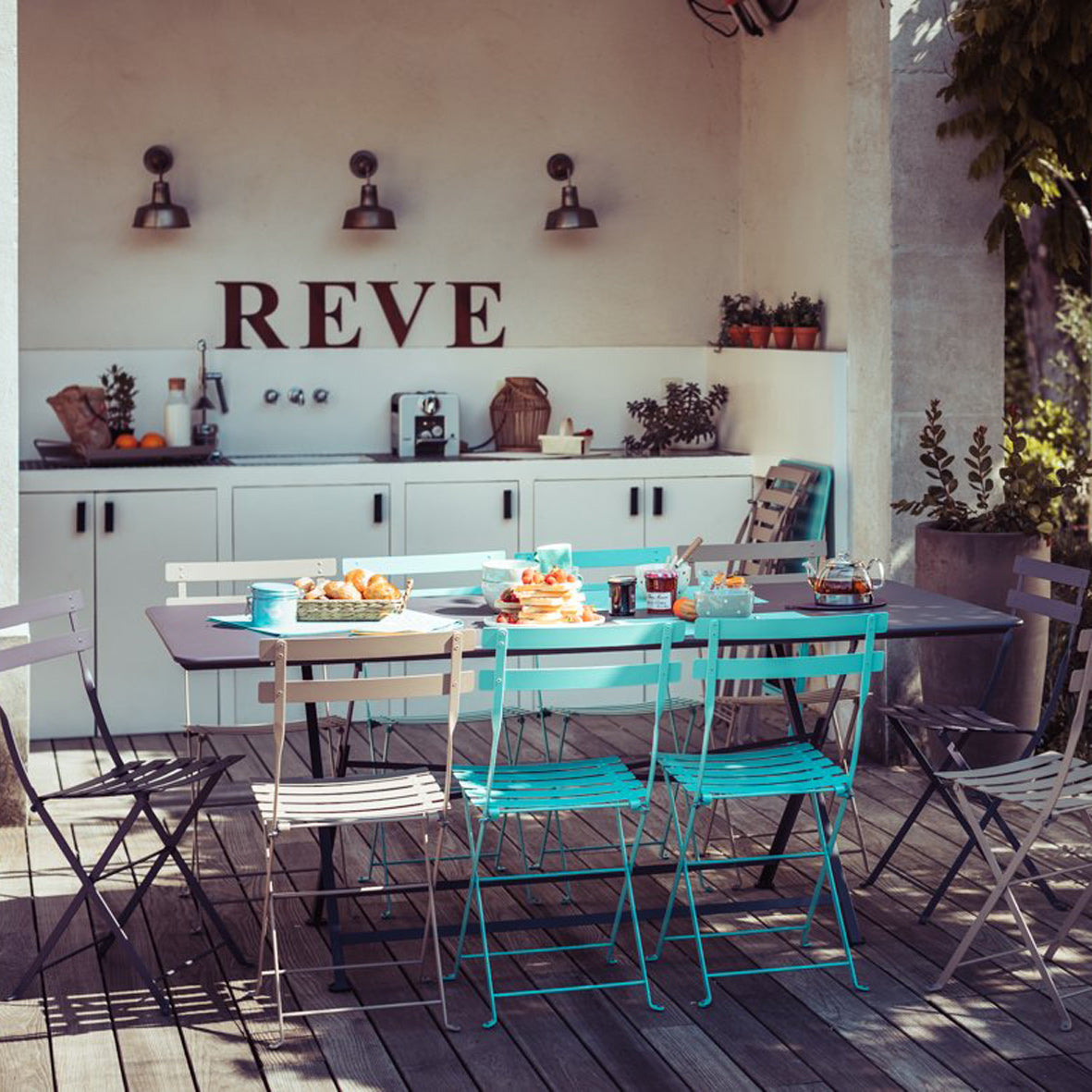 Caractere Tables by Fermob, showing angle view of table with chairs in the live shot.