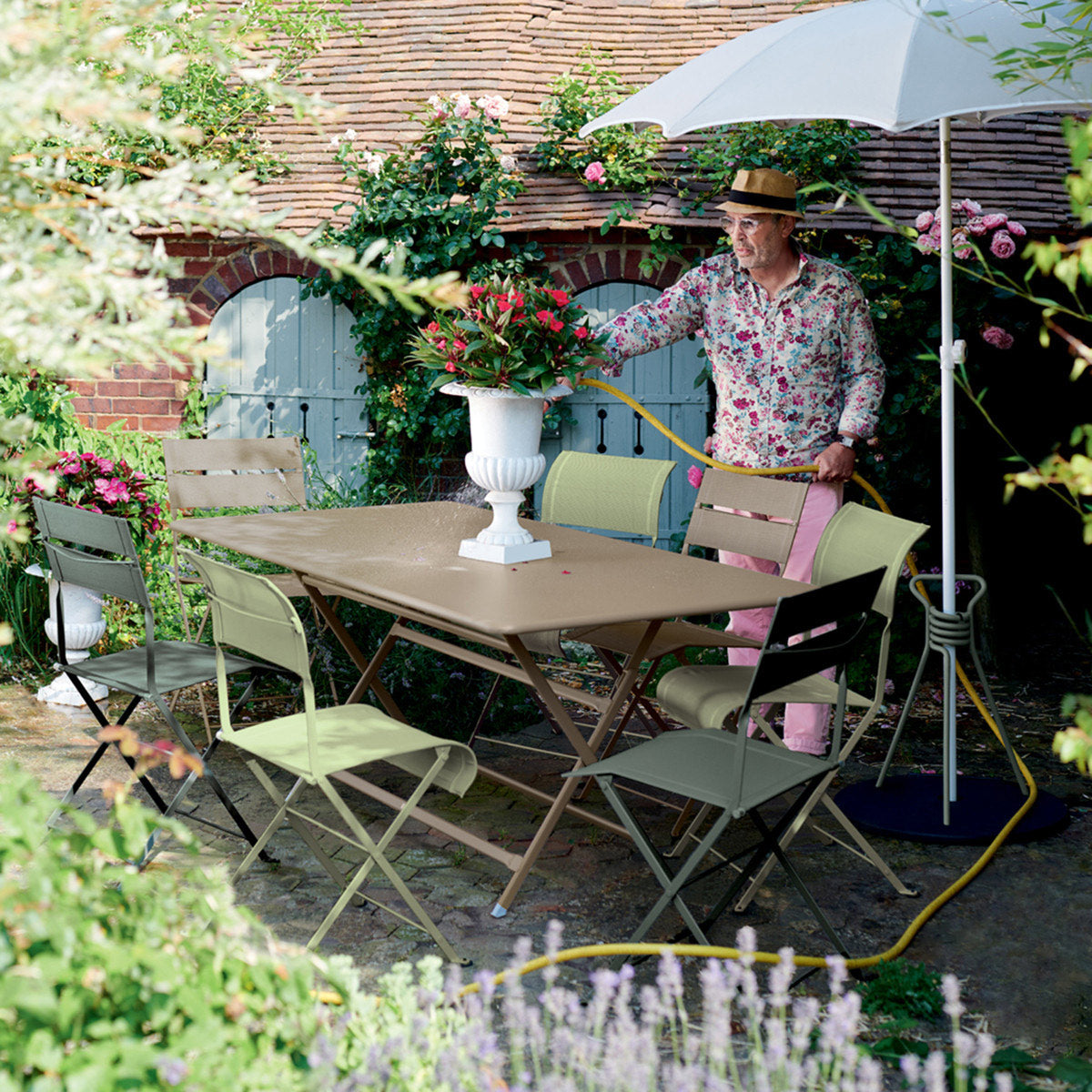 Caractere Tables by Fermob, showing angle view of table with chairs in the live shot.