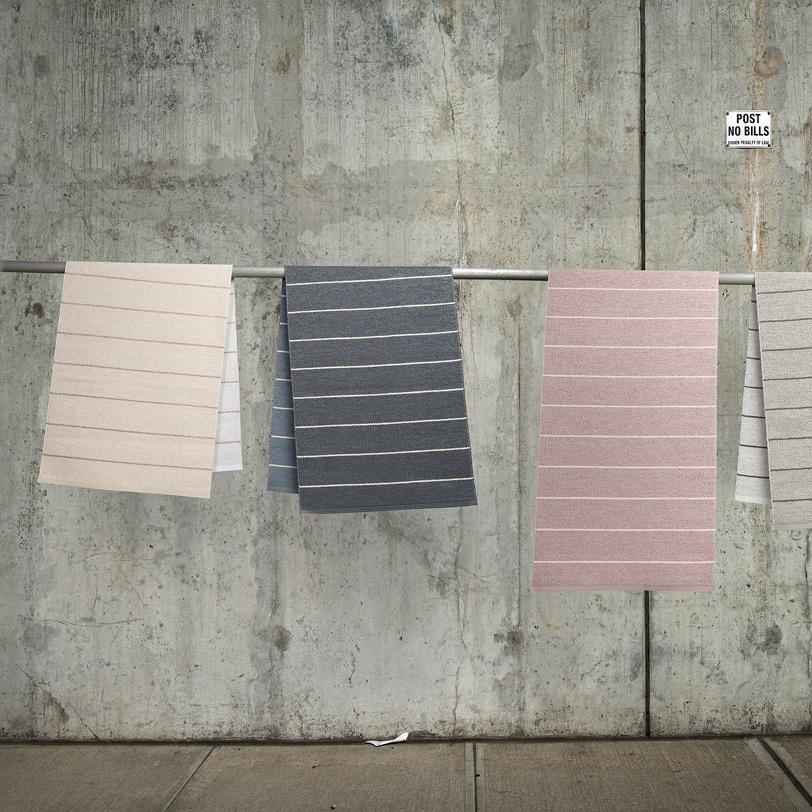 Carl Warm Grey & Fossil Grey Rug by Pappelina, showing different colors of carl rug in live shot.