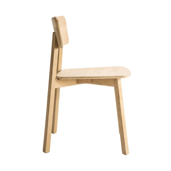 Casale Dining Chair by Ethnicraft, showing side view of dining chair in varnished natural oak finish.