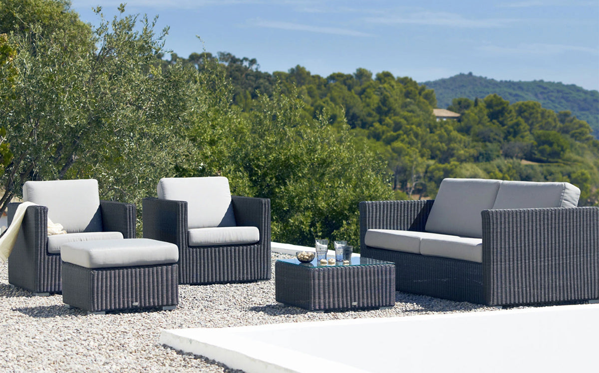 Chester Clear Glass Coffee Table by Cane-Line - showing of chester clear glass coffee table with sofa & Chairs in live shot.