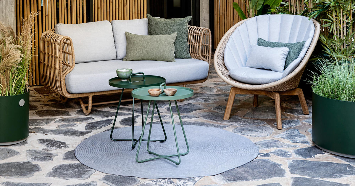 Circle Rug by Cane-Line, showing circle rug with tables, sofa & chair in live shot.