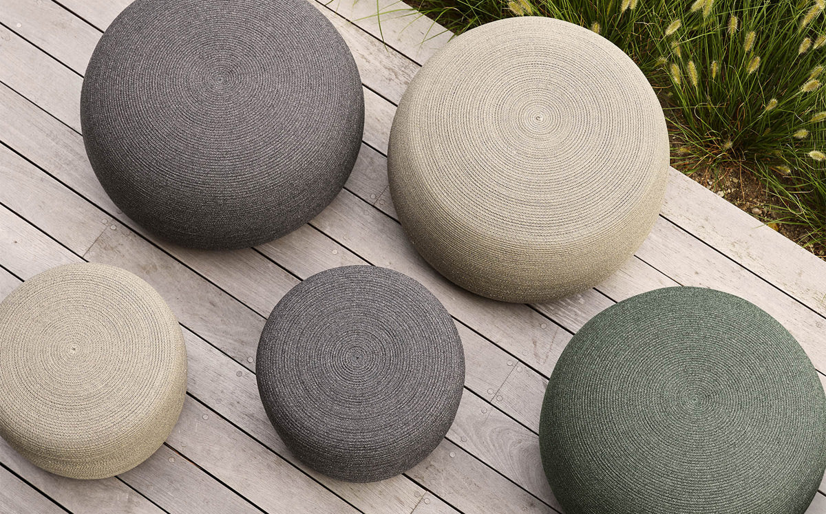 Circle Footstool by Cane-Line, showing circle footstools in live shot.