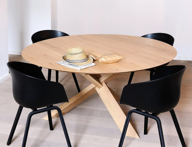 Circle Dining Table by Ethnicraft, showing circle dining table with chairs in the live shot.