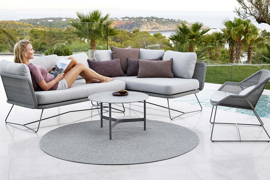 Circle Rug by Cane-Line, showing circle rug with table, sofa & chair in live shot.
