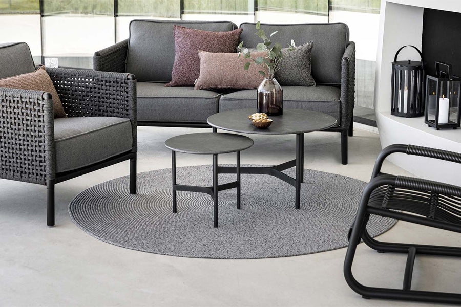 Circle Rug by Cane-Line, showing circle rug with tables, sofa & chair in live shot.