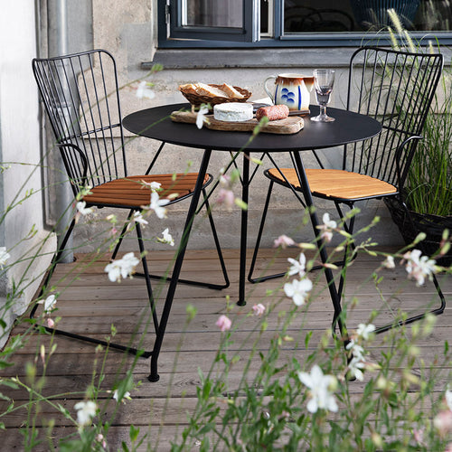 Circum Outdoor Cafe Table by Houe, showing circum outdoor cafe table with chairs in live shot.
