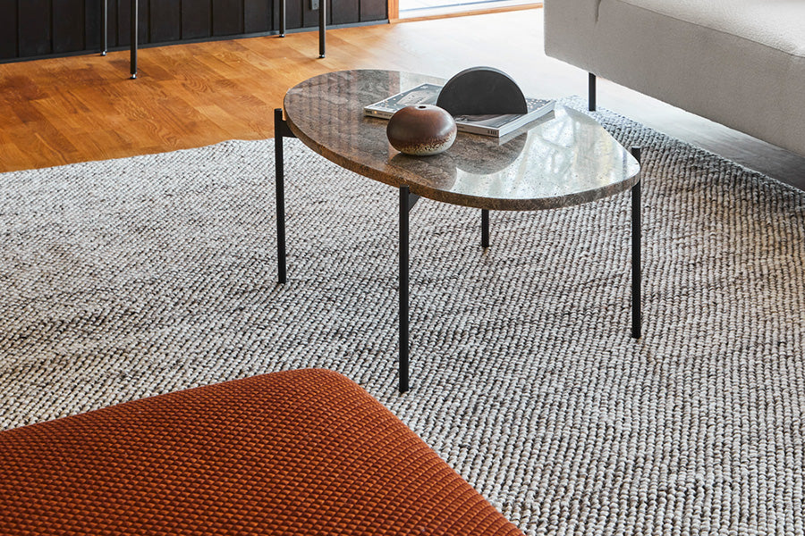 Collar Ottoman by Woud, showing closeup veiw of collar ottoman in live shot.