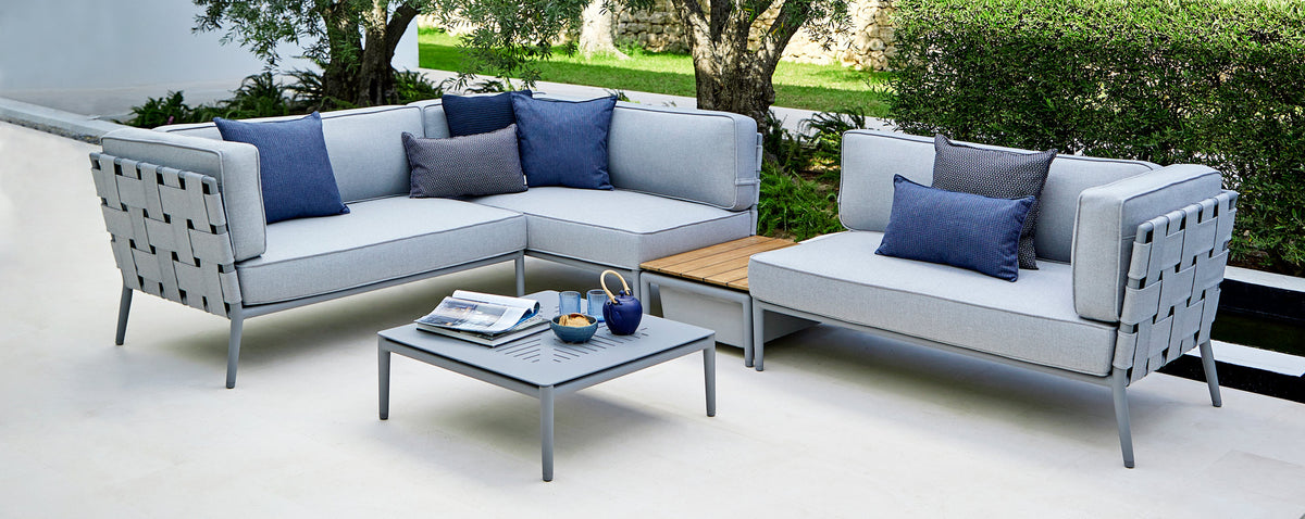Conic Box Table by Cane-Line, showing conic box table in live shot.