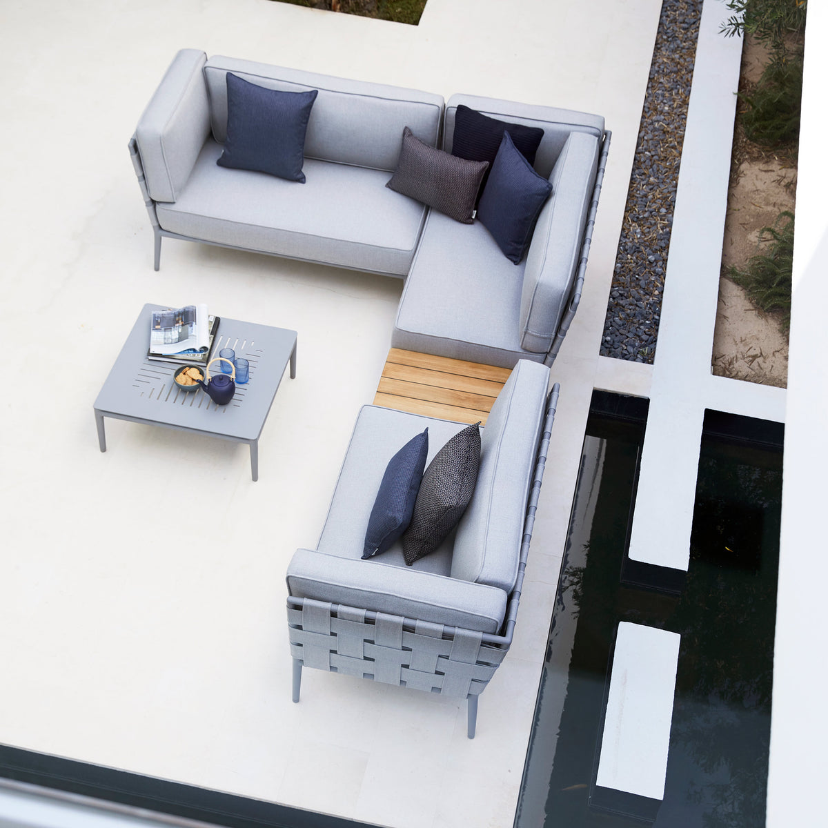 Conic Box Table by Cane-Line, showing conic box table in live shot.