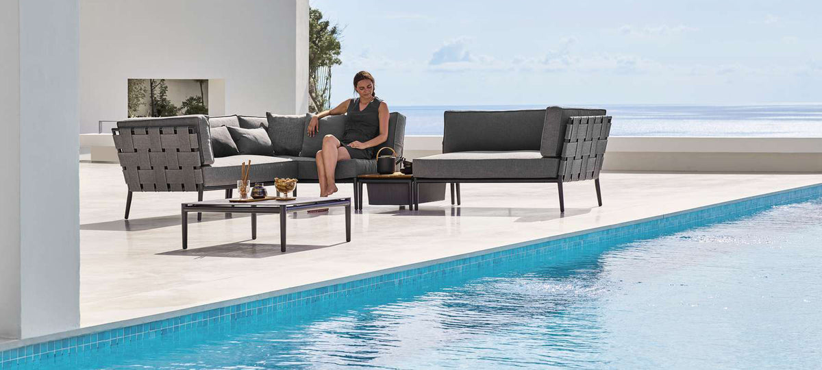 Conic Coffee Table by Cane-Line, showing conic coffee table in live shot.