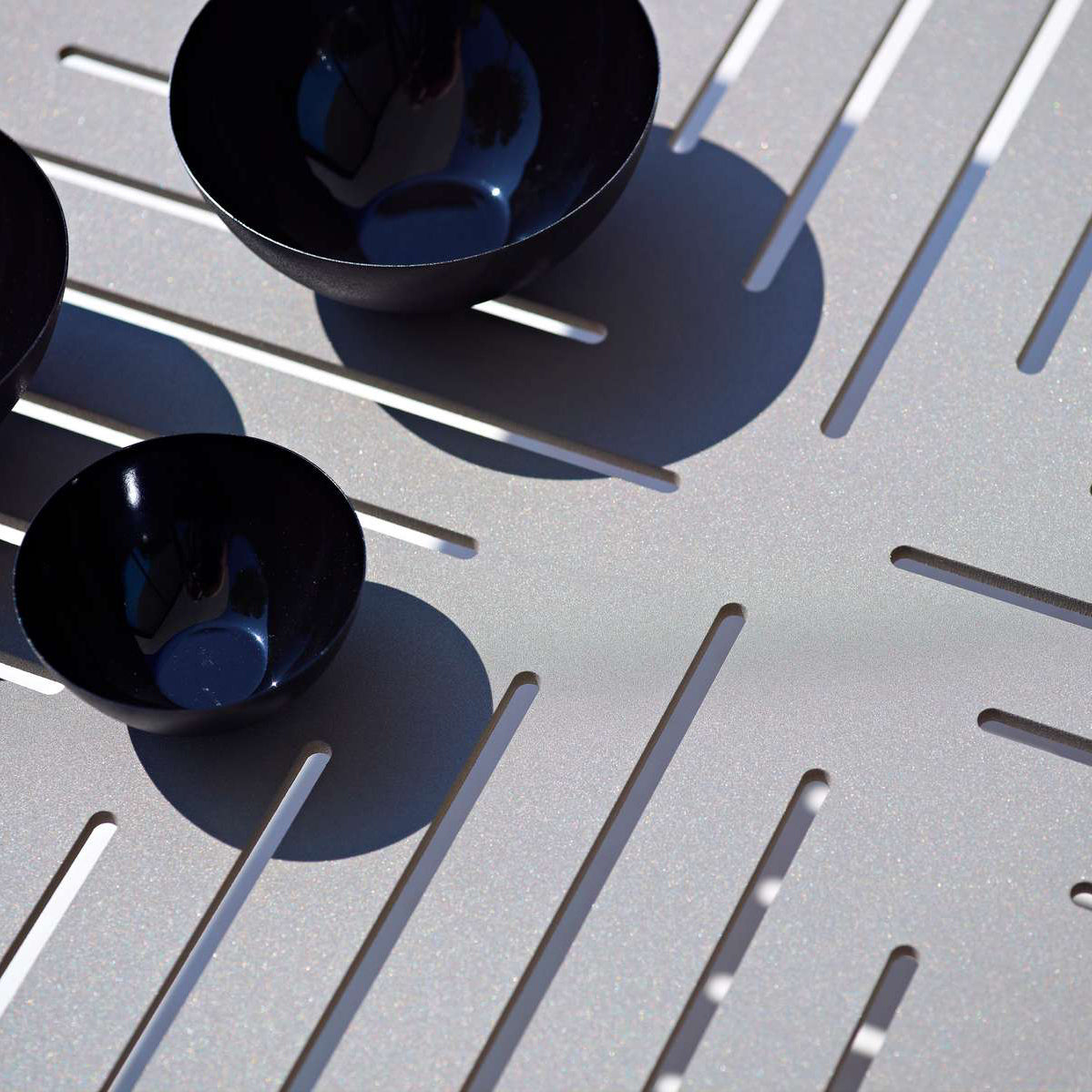 Conic Coffee Table by Cane-Line, showing closeup view of conic coffee table in live shot.