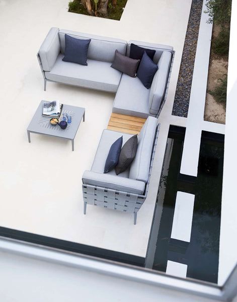 Conic Coffee Table by Cane-Line, showing conic coffee table in live shot.