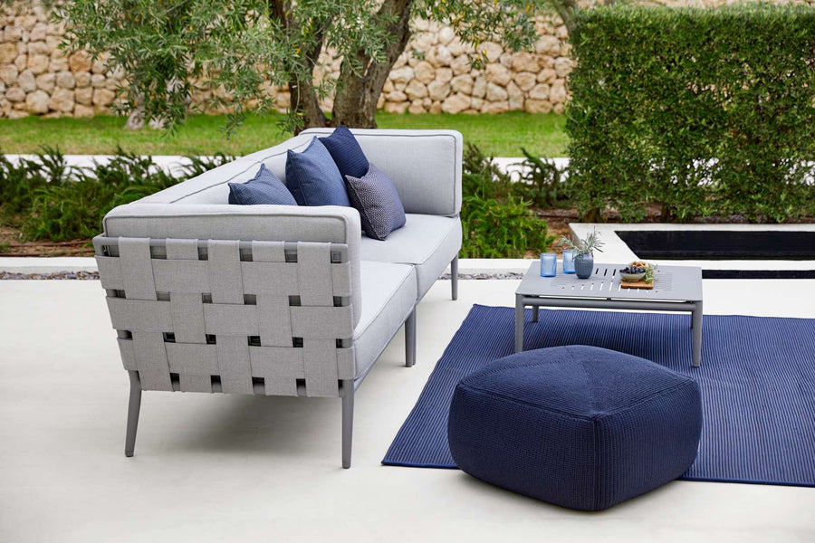 Conic Coffee Table by Cane-Line, showing conic coffee table in live shot.