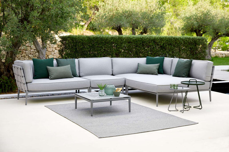 Conic Coffee Table by Cane-Line, showing conic coffee table in live shot.