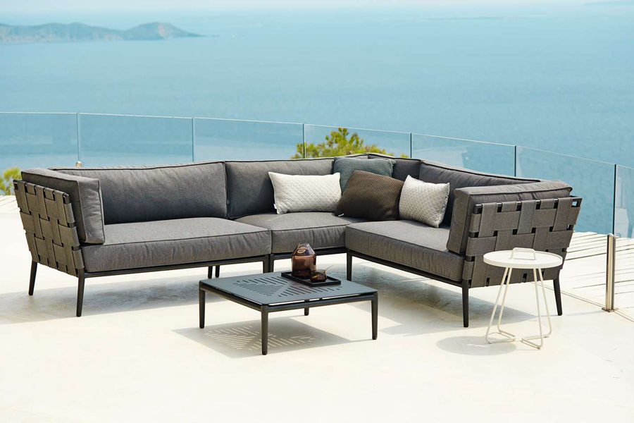 Conic Coffee Table by Cane-Line, showing conic coffee table in live shot.