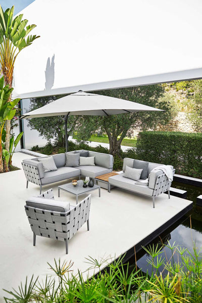 Conic Coffee Table by Cane-Line, showing conic coffee table in live shot.