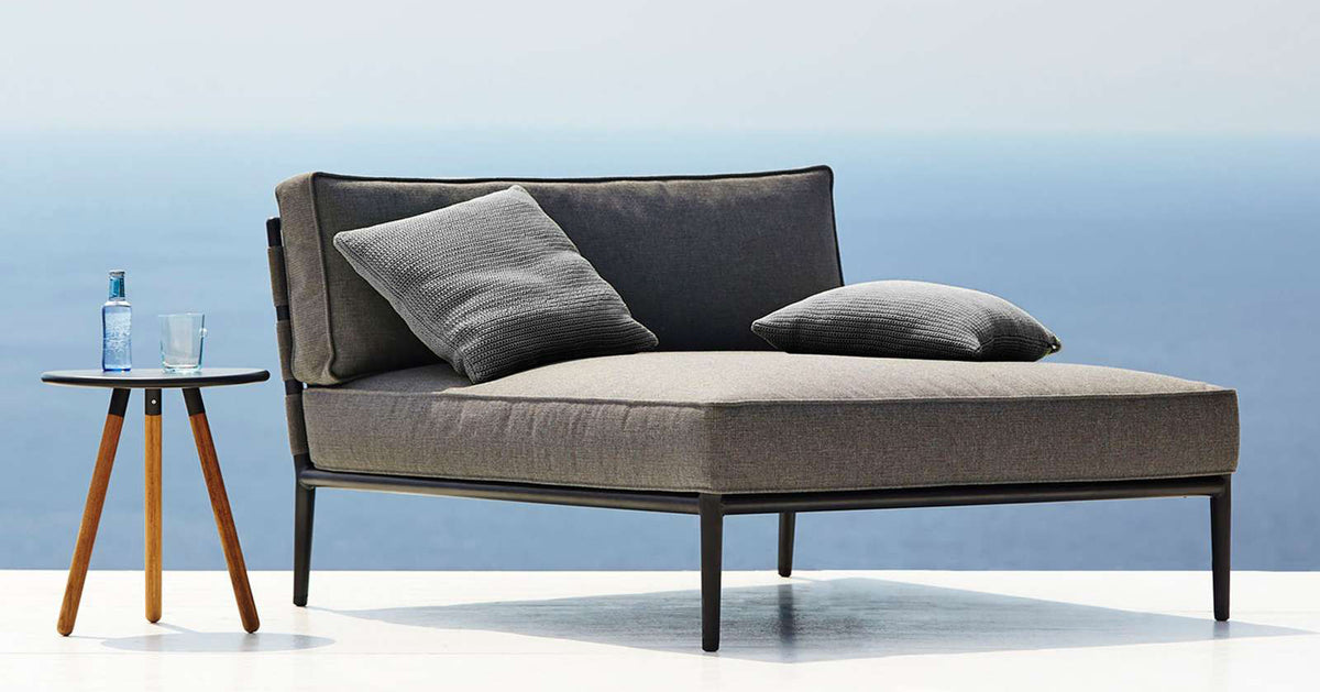 Conic Daybed Module by Cane-Line, showing conic daybed module with table in live shot.
