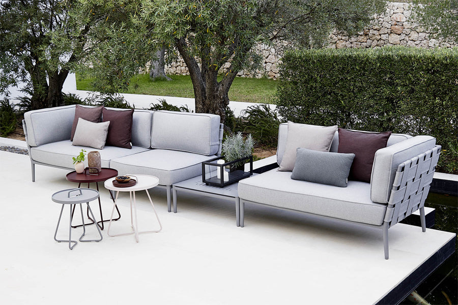 Conic Outdoor Module by Cane-Line, showing conic outdoor modules with tables in live shot.