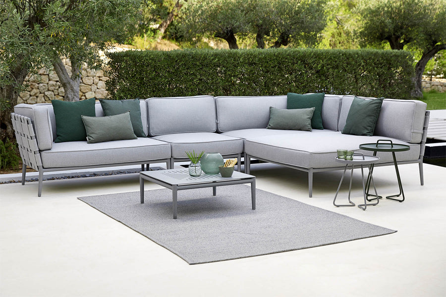 Conic Outdoor Module by Cane-Line, showing conic outdoor modules with tables in live shot.