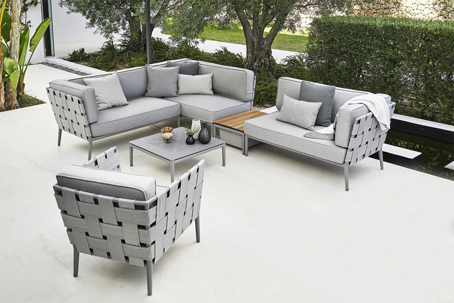 Conic Outdoor Module by Cane-Line, showing conic outdoor modules with chair & table in live shot.