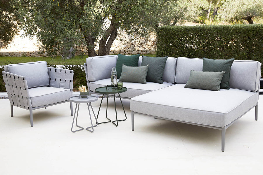 Conic Outdoor Module by Cane-Line, showing conic outdoor modules with chair & table in live shot.