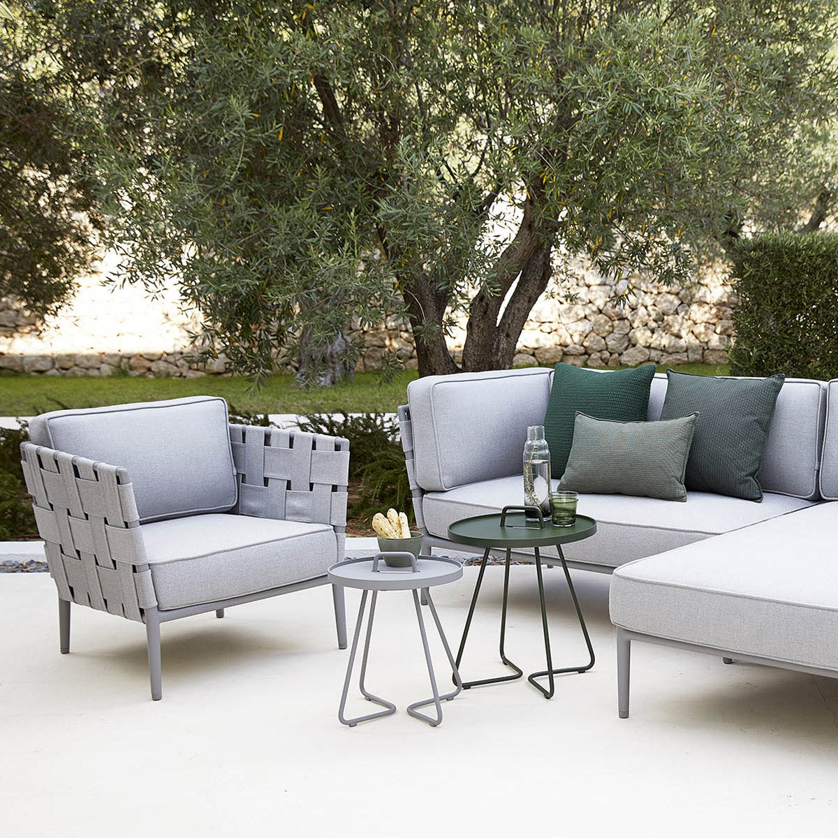 Conic Outdoor Lounge Chair by Cane-Line, showing conic outdoor lounge chair in live shot.