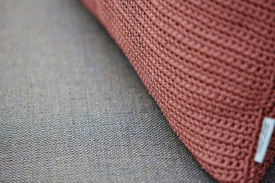 Conic Outdoor Lounge Chair by Cane-Line, showing closeup view of conic outdoor lounge chair in live shot.