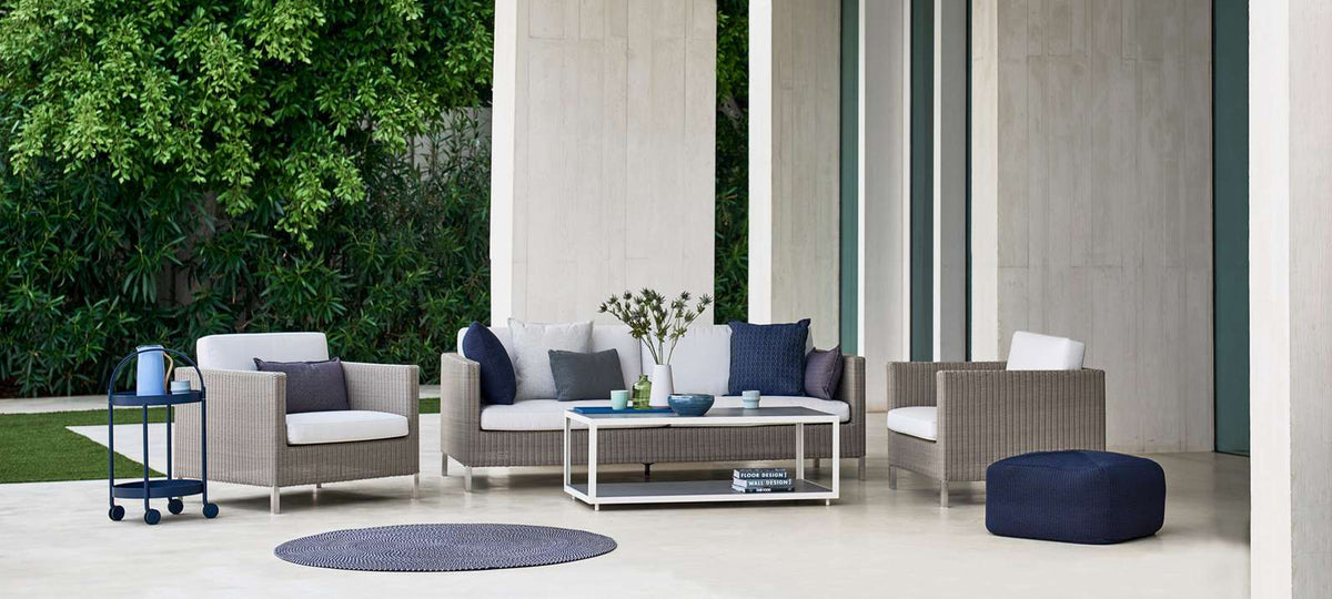 Connect 3 Seater Sofa by Cane-Line, showing connect 3 seater sofa with chairs & tables in live shot.