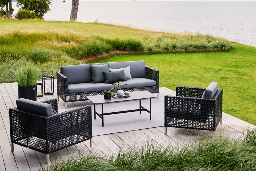 Connect 3 Seater Sofa by Cane-Line, showing connect 3 seater sofa with table & chairs in live shot.