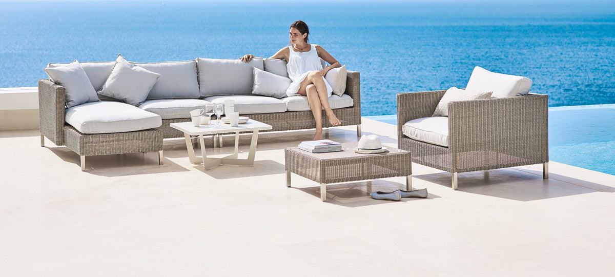 Connect Footstool by Cane-Line, showing connect footstool in live shot.